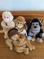 Group shot of all four Coca-Cola monkey/gorilla plush toys