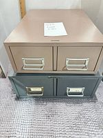 Front view showing both two-drawer cabinets stacked, handles and colors visible