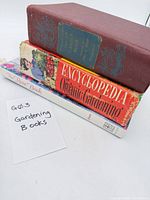 Three gardening books stacked showing titles and spines