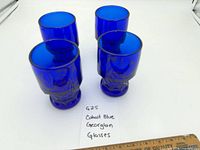 Group view of four cobalt blue Georgian tumblers