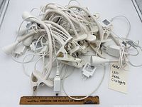 Pile of white IKEA LED clip lights showing quantity and overall style