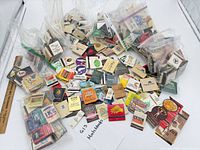 Overall view of multiple bags of matchbooks spread out