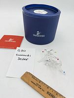 Figurine, box, certificate, ruler for scale