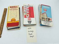 Stack of assorted folded maps showing Shell Pacific Southwest, AAA Chicago Streets, Phillips 66 Kentucky & Tennessee