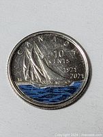Reverse side showing colorized blue water and Bluenose schooner with CANADA 10 CENTS 1921 2021 legends