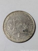 Reverse view with maple leaf and motto