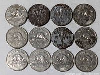 All twelve coins laid out in three rows showing obverse design and dates