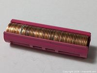 Full roll of pennies in pink plastic holder