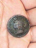 Obverse view showing worn King George bust and partial legend