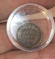 Reverse side of 1900 Indian Head Cent showing ONE CENT wreath design in capsule