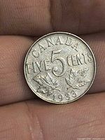 Reverse of 1933 Canada 5-cent coin showing denomination and maple leaves