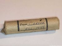 Full view of rolled coin wrapper with handwritten 1948 notation