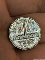 Reverse of 1951 Canadian commemorative nickel showing refinery design and inscriptions