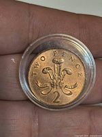 Reverse of copper 2 pence coin in capsule
