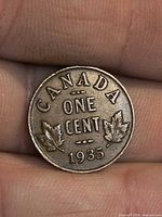Reverse of 1935 Canada one cent coin showing denomination, maple leaves and date