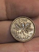 Reverse of 1944 Canada 1 cent coin showing maple leaf design, denomination and date