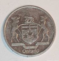 Obverse of aluminum Ontario medallion showing coat of arms