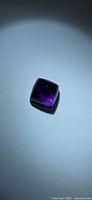 Square sugarloaf-cut amethyst showing overall shape and deep purple color