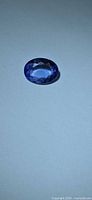 Front view of oval-cut Tanzanite on neutral background