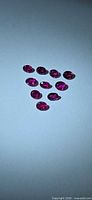 Ten small oval rubies arranged in triangle