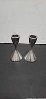 Pair of stainless steel candlesticks front view