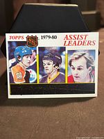 Front of Topps Assist Leaders card showing three player images and unscratched bar