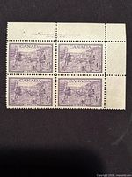 Front view of four-stamp plate block with selvedge and imprint