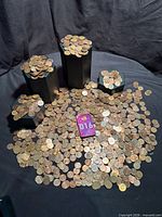 Full view of approximately 5 lb of loose pennies spread out with some stacked