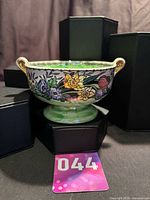 Front view of footed floral bowl showing handles and exterior pattern