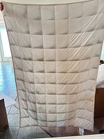 Plain light gray reverse side showing grid-stitched weight pockets