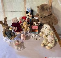 Group shot of all plush toys, rocking chairs, pig, alphabet cubes and tea set