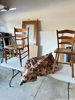 Two chairs and folded floral umbrella on table