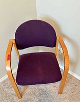 Front view of wood frame chair with purple fabric