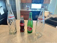 Front view of all four soda bottles on countertop