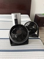 Front view showing two Honeywell desk fans and one silver tower fan