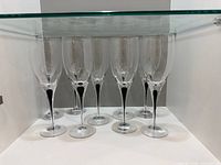 Nine Orrefors Intermezzo Black white-wine glasses on shelf