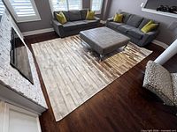 Top view of entire cowhide striped rug in living room setting