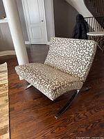 Front angled view of patterned fabric chair showing seat, backrest, and chrome legs