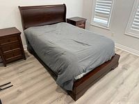 Overall view of bed frame and mattress from left front