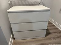 Front view of white 3-drawer chest