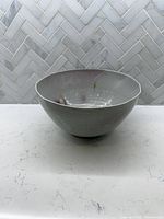 Oblique front view of ceramic bowl showing exterior glaze and shape