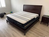 Full view of bed frame and mattress from foot end