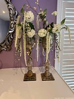 Full view of both glass vases with arrangements