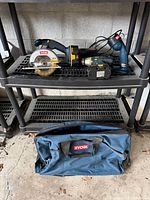 Circular saw, drill, flashlight, battery, charger on shelving