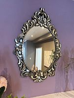 Front view of ornate Venetian mirror on wall