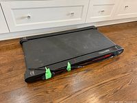 Top and side view of black vibration pad showing overall design and surface