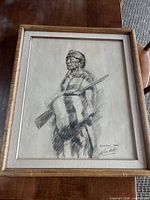 Framed charcoal sketch entire piece on table