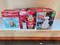 Group shot of three boxed Christmas inflatables