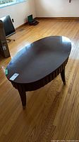 Full view of oval coffee table top and legs