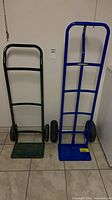 Both hand trucks side by side showing size and color difference